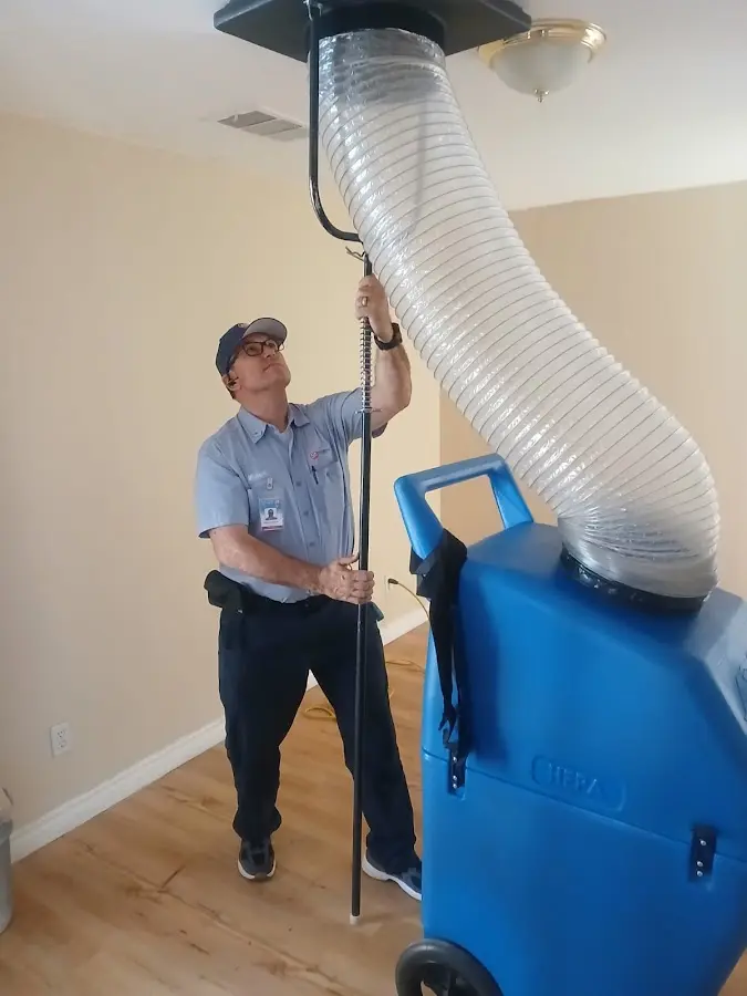 Furnace Tune-Up technician using HEPA equipment in Orchard Homes